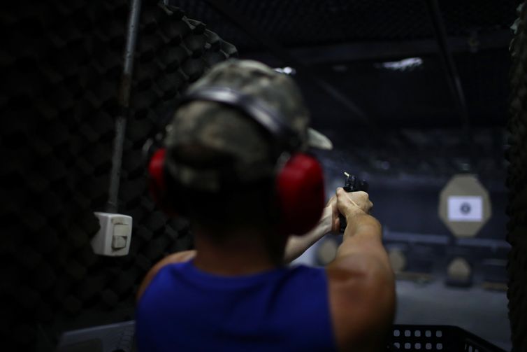 A member of the Colt 45 shooting club fires a gun in Rio de Janeiro, Brazil January 15, 2019. REUTERS/Pilar Olivares